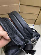 Monogram mini backpack strap ends with stitched webbing and metal buckles