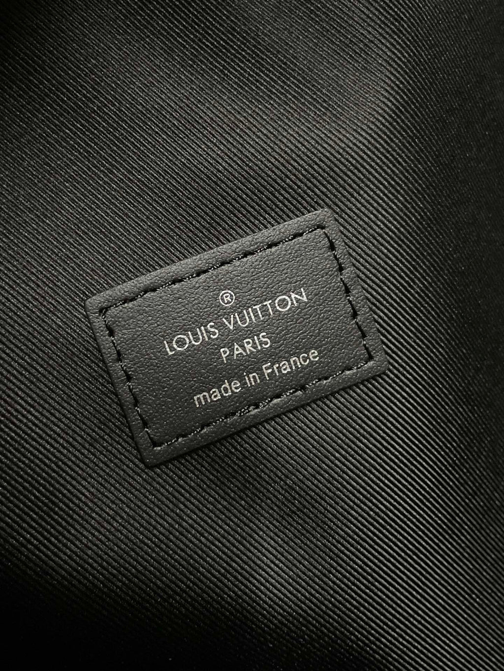 Louis Vuitton Paris label on dark monogram mini backpack, made in France