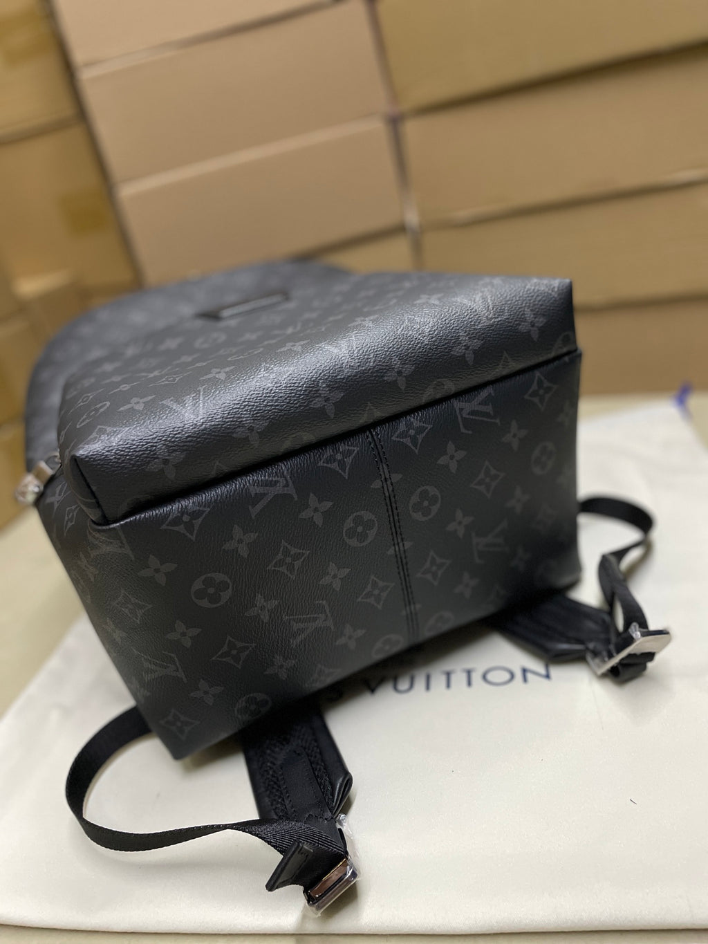 Dark monogram mini backpack with textured flap top and attached crossbody strap