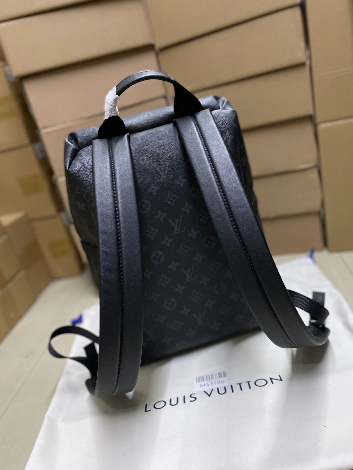 Men’s black monogram backpack with side straps and top grab handle