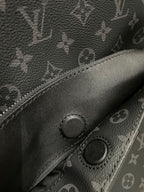 Dark monogram mini backpack front pocket with snap buttons and stitched edge