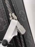 Louis Vuitton zipper pull with metal LV logo on dark monogram toiletry pouch