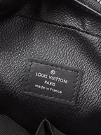 Louis Vuitton leather label on black pouch, Paris made in France