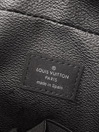 Louis Vuitton small bag interior label reading 'Louis Vuitton Paris, made in Spain'