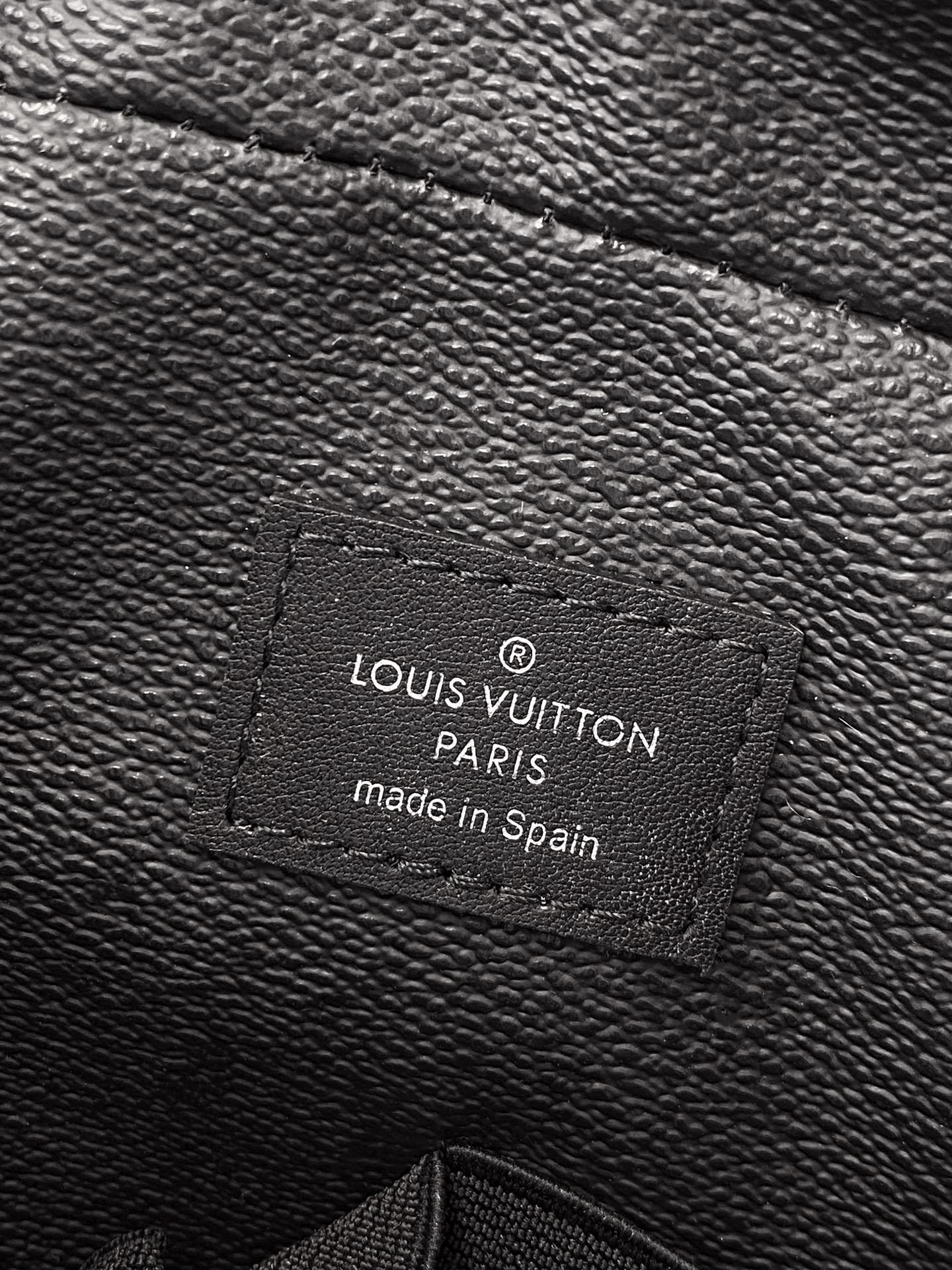 Louis Vuitton bag leather label reading LOUIS VUITTON PARIS made in Spain