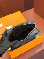 Louis Vuitton small bag open to reveal black fabric lining and interior zipper pocket