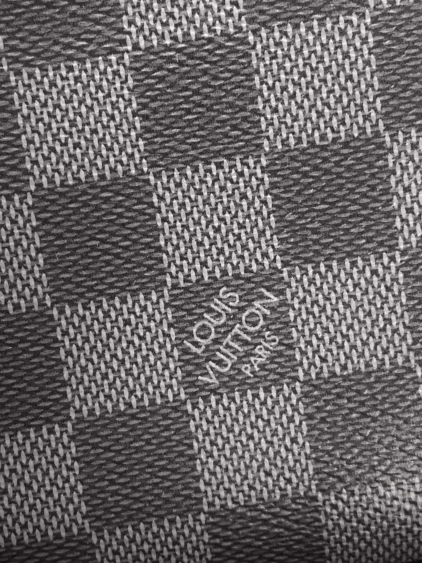 Louis Vuitton checkered Damier pattern fabric on dark pouch surface