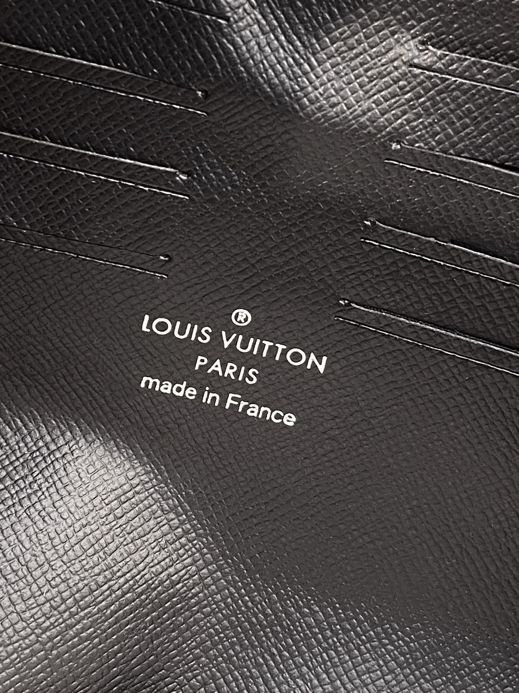 Louis Vuitton Paris made in France embossed on black textured leather