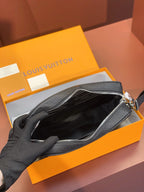 Louis Vuitton leather crossbody bag open, showing black interior lining