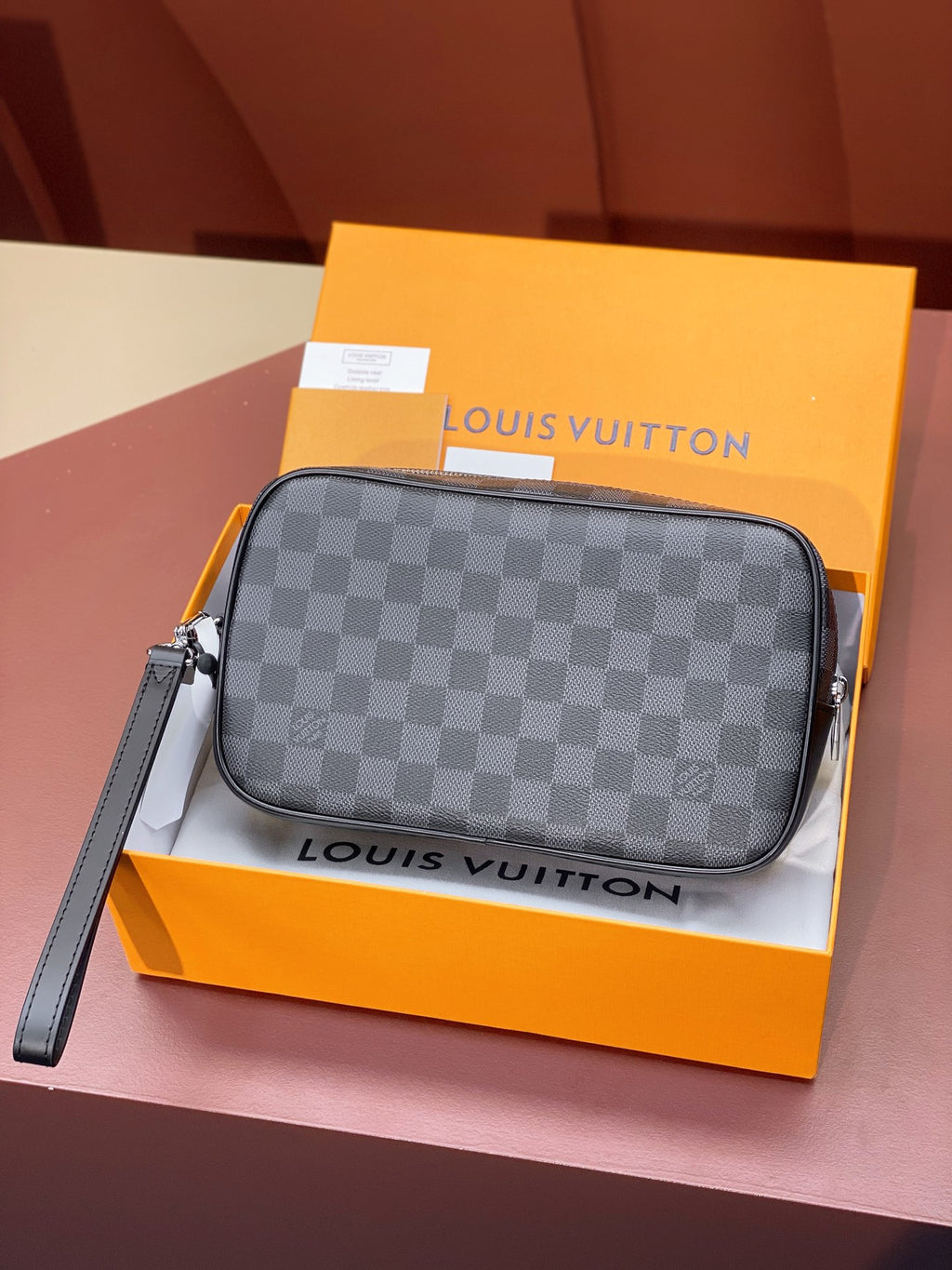 Louis Vuitton small crossbody bag with dark gray Damier checker exterior and adjustable strap
