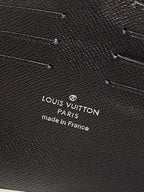 Louis Vuitton Paris logo and Made in France text on dark textured bag leather