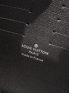 Louis Vuitton leather bag close-up with embossed logo text "Louis Vuitton Paris made in France"