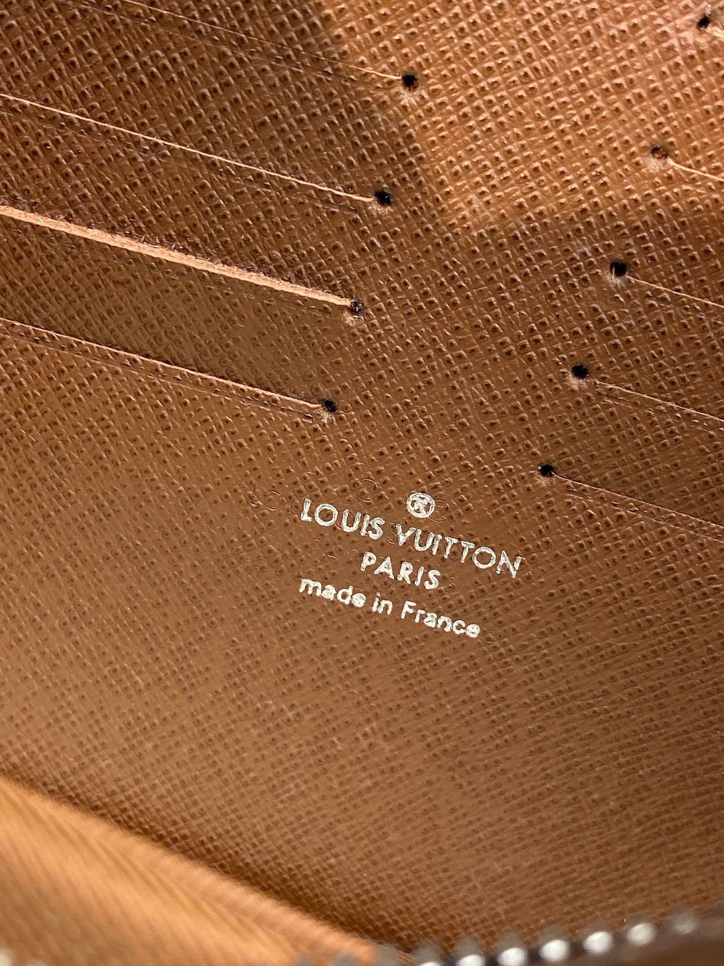 Louis Vuitton small bag leather base with embossed text 'Paris' and 'made in France'