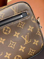 Louis Vuitton small bag close-up with monogram leather, zipper track, and metal tab