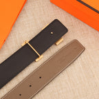 Hermes leather belt side view, dark strap with gold-tone buckle and taupe keeper