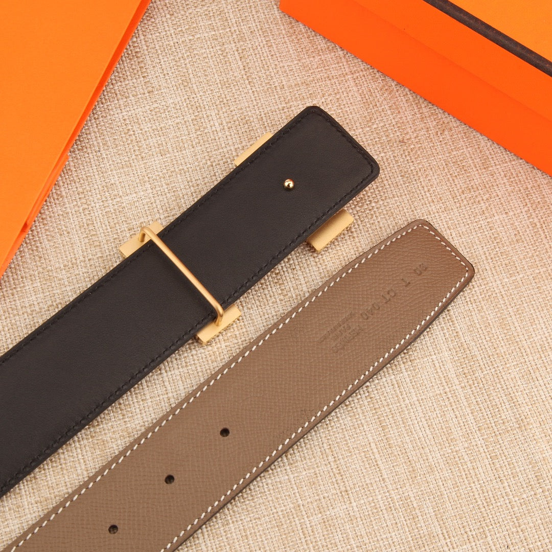 Hermes leather belt side view, dark strap with gold-tone buckle and taupe keeper