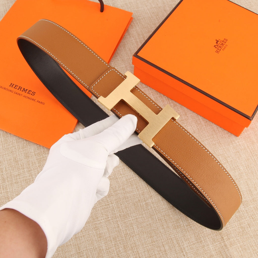Hermes leather belt with tan strap, dark lining, and silver buckle
