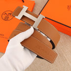 Hermes leather belt with tan strap, white stitching, and silver buckle detail