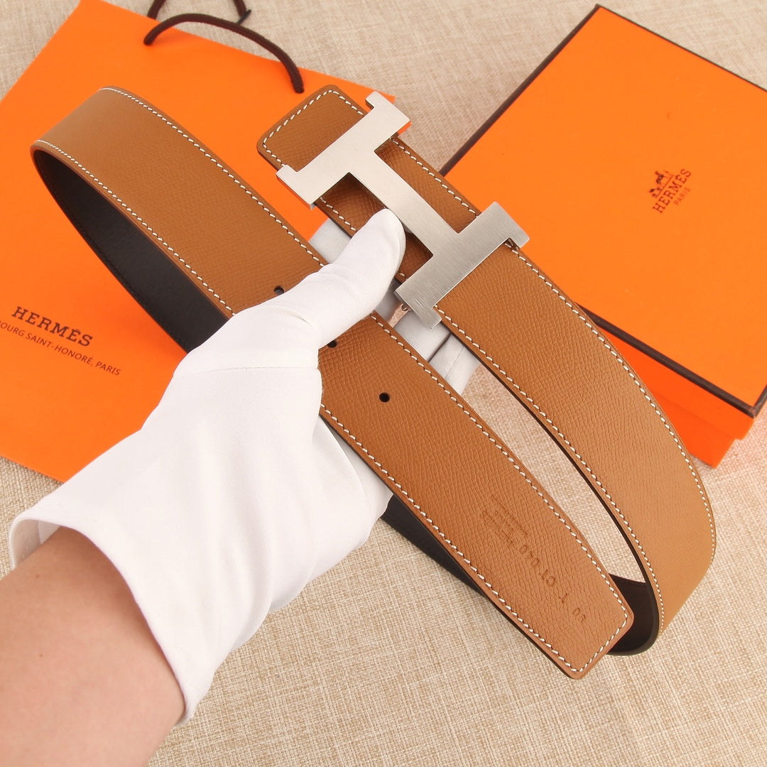 Hermes leather belt with tan strap and silver H buckle, shown from above