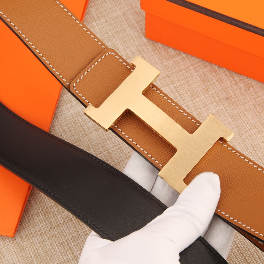 Hermes leather belt close-up of tan strap with contrast stitching and silver buckle