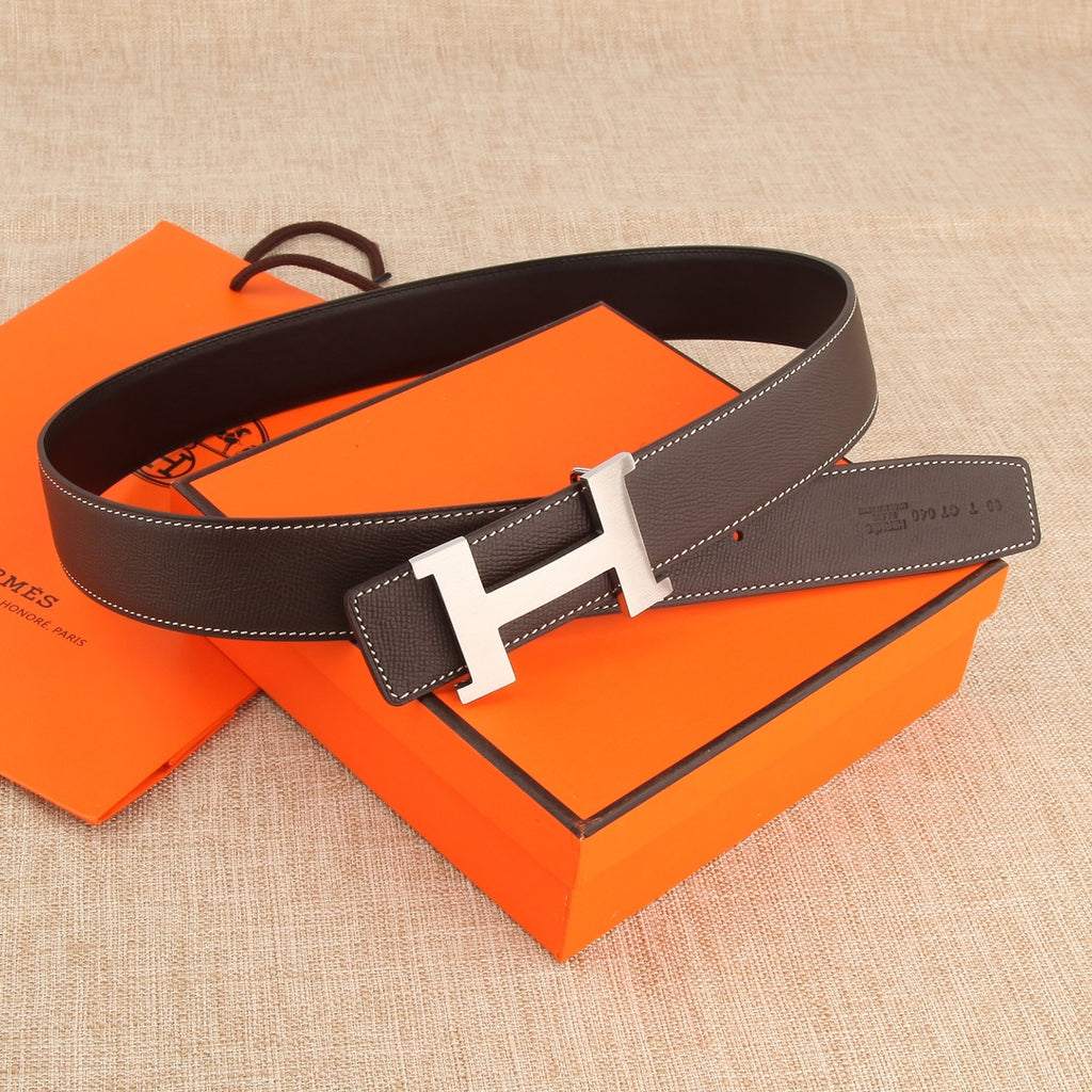 Hermes belt with dark brown leather strap, silver H buckle, and white contrast edging