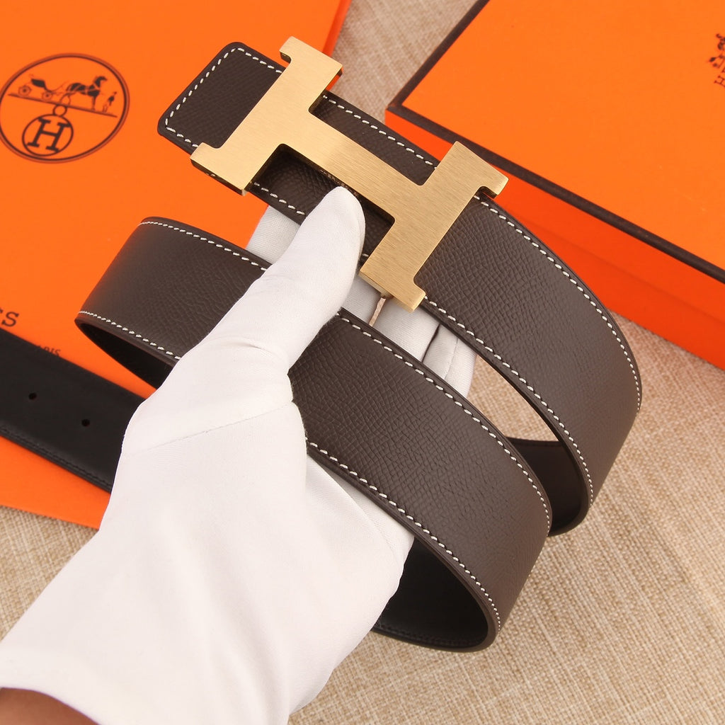 Hermes belt with dark brown leather strap, silver H buckle, and visible white topstitching