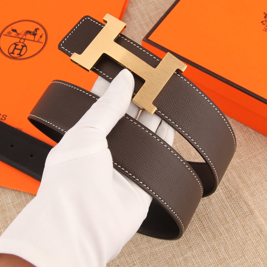 Hermes belt with dark brown leather strap, silver H buckle, and visible white topstitching