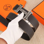 Leather belt with silver-tone H buckle, visible stitched trim, and adjustment holes