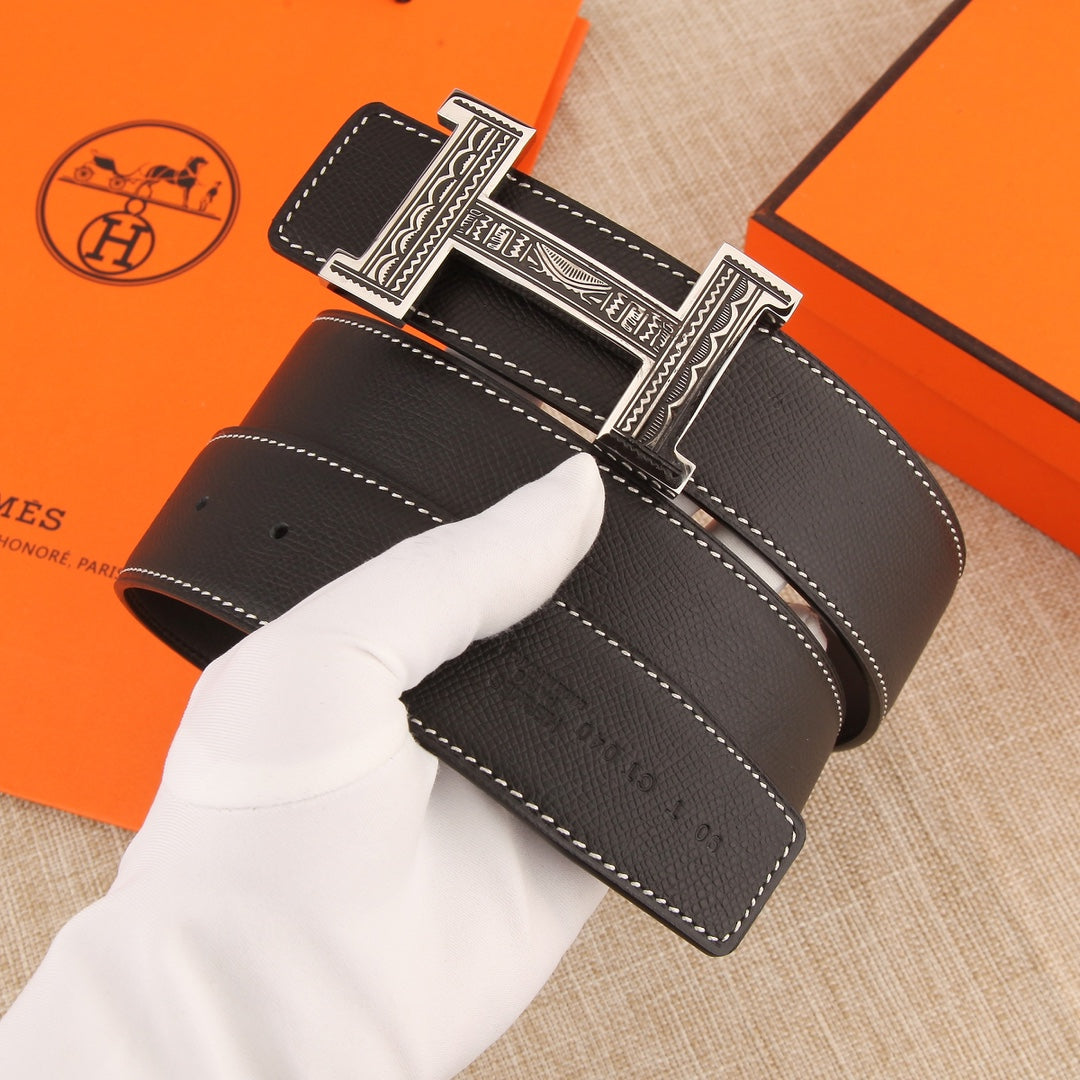 Leather belt with silver-tone H buckle, textured dark leather, and white stitched edges