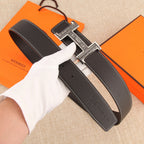 Leather belt with silver-tone H buckle and multiple adjustment holes, white stitching