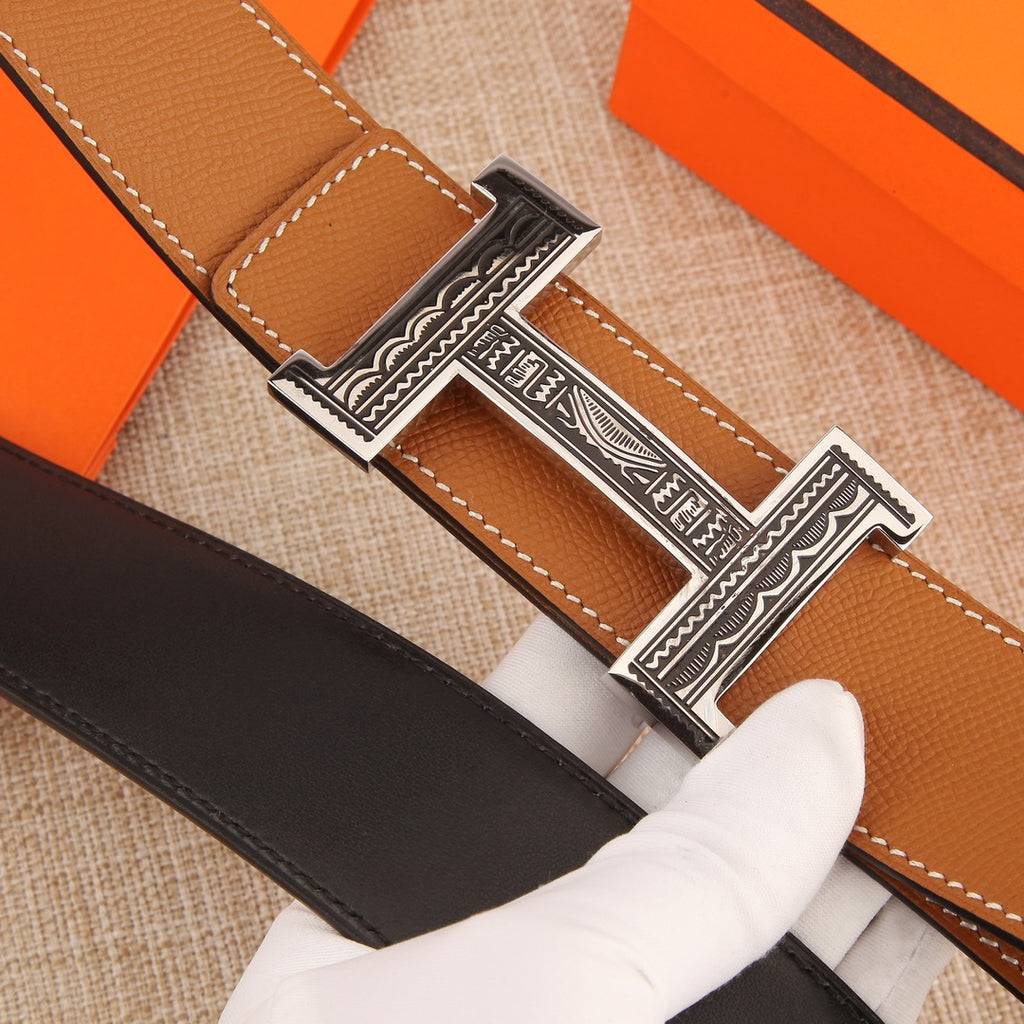 Hermes belt detail: tan and dark brown straps with silver-tone H buckle.