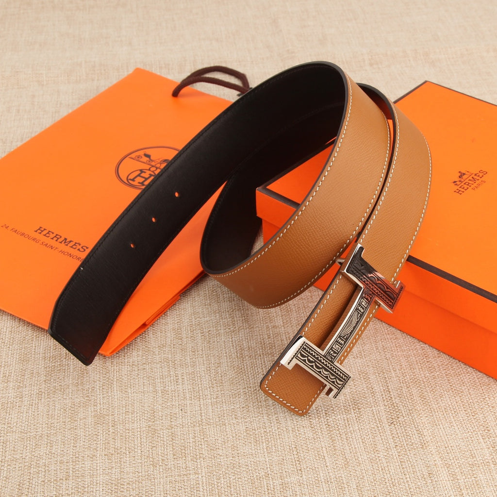 Hermes belt set view: black strap and tan strap with silver-tone H buckle.