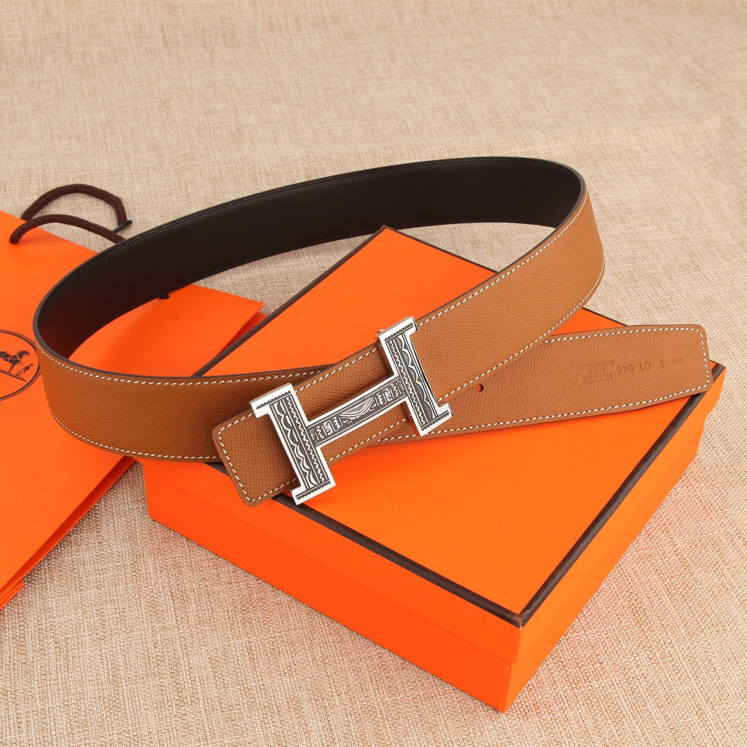 Hermes belt: tan leather strap with silver-tone H buckle and stitched edge.