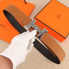 Hermes belt in tan leather with stitched edges and silver-tone H buckle.