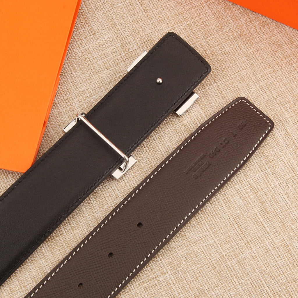 Brown leather belt with silver buckle and perforated strap holes, dark keeper