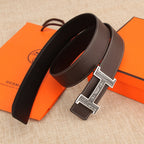 Brown leather belt with ornate silver buckle and matching keeper loop