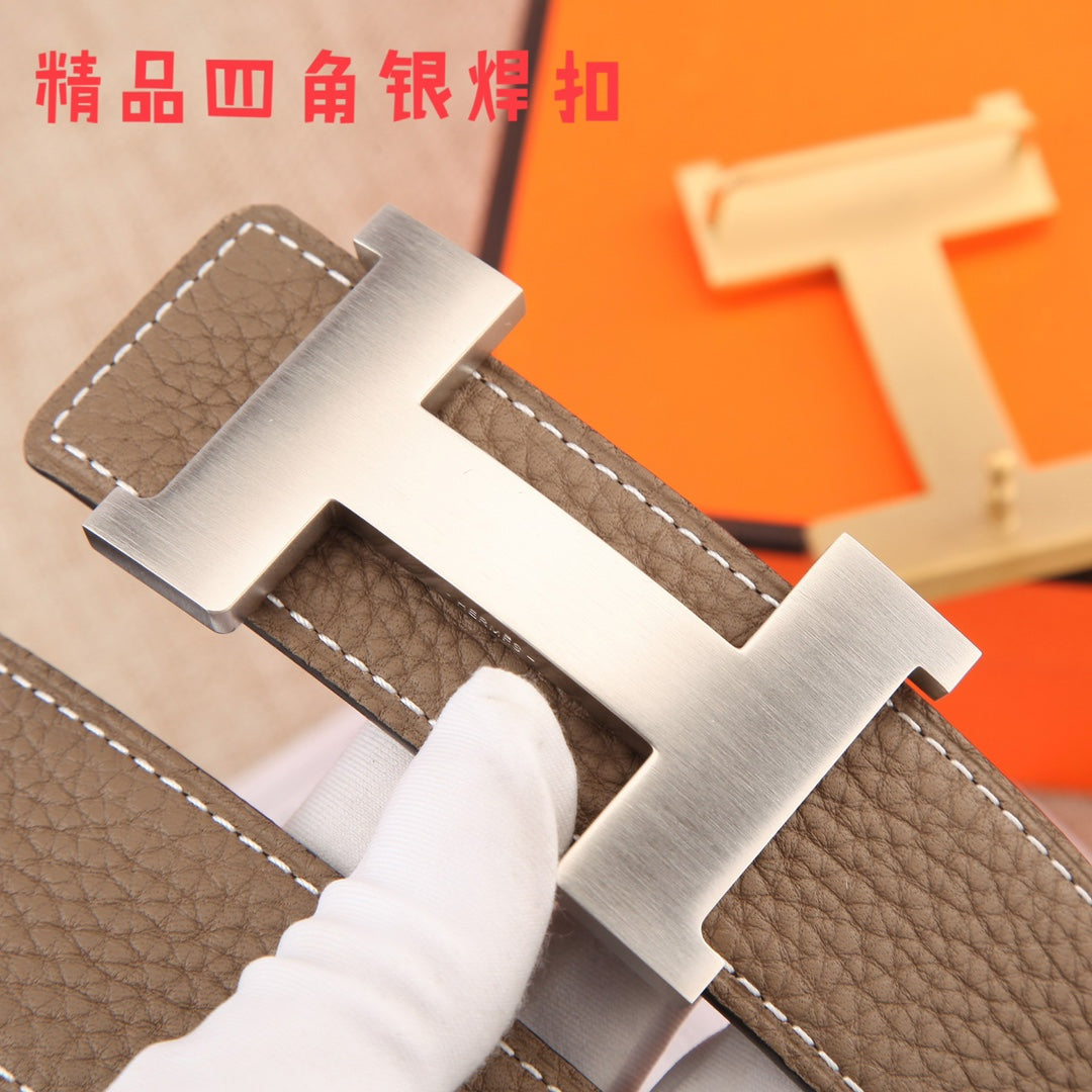 Hermes belt buckle close-up: silver H hardware on dark brown textured leather strap
