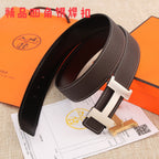 Brown leather belt with gold-tone buckle, curved profile, and white contrast stitching.
