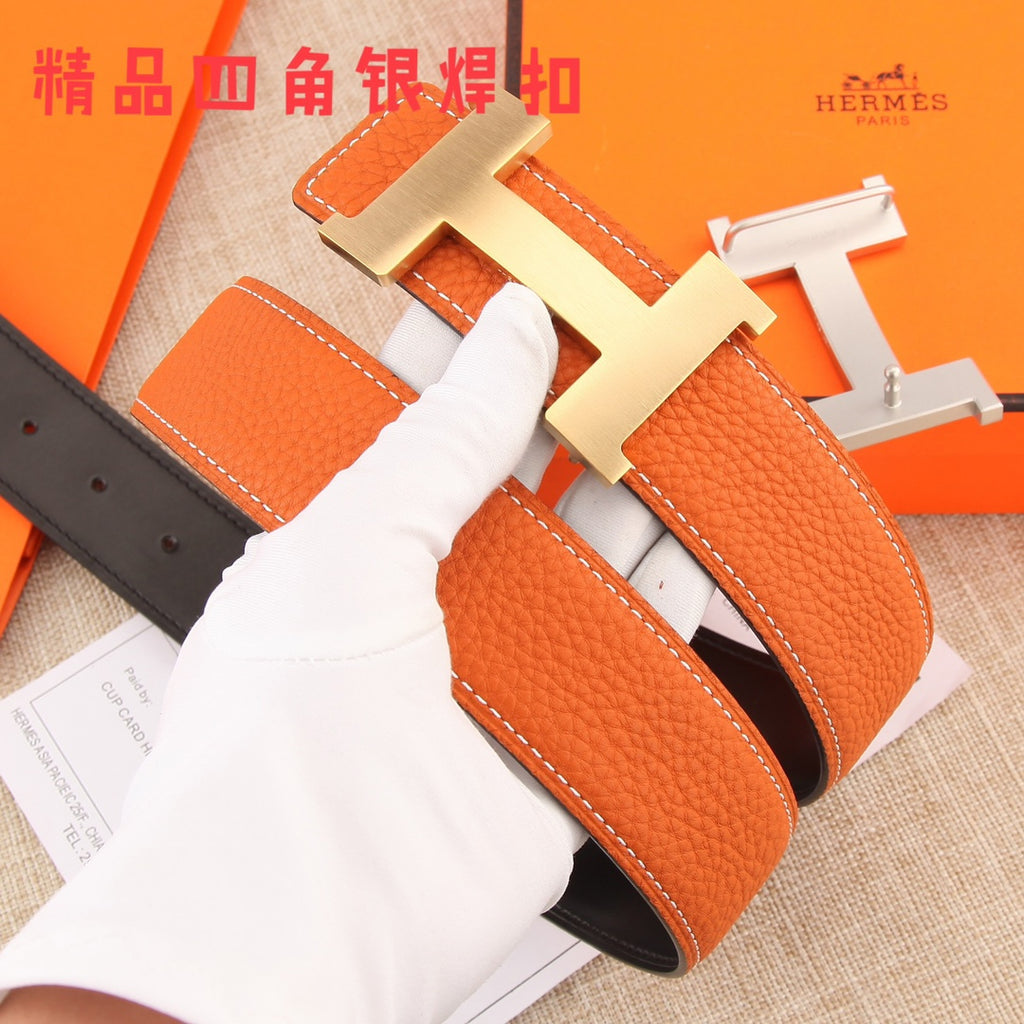 Hermes leather belt with orange outer and black inner, silver H buckle detail