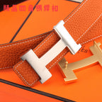 Hermes leather belt close-up: orange strap with silver H buckle and stitching