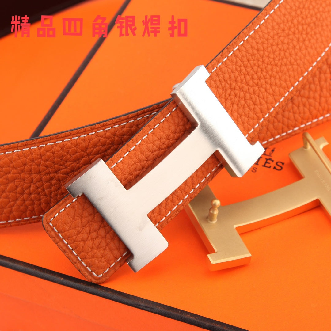 Hermes leather belt close-up: orange strap with silver H buckle and stitching