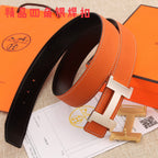 Hermes leather belt with black lining, orange outer strap, silver H buckle