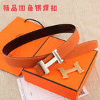 Hermes leather belt with orange strap, dark interior, silver H buckle