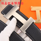 Black pebbled leather belt with large gold-tone H buckle close-up