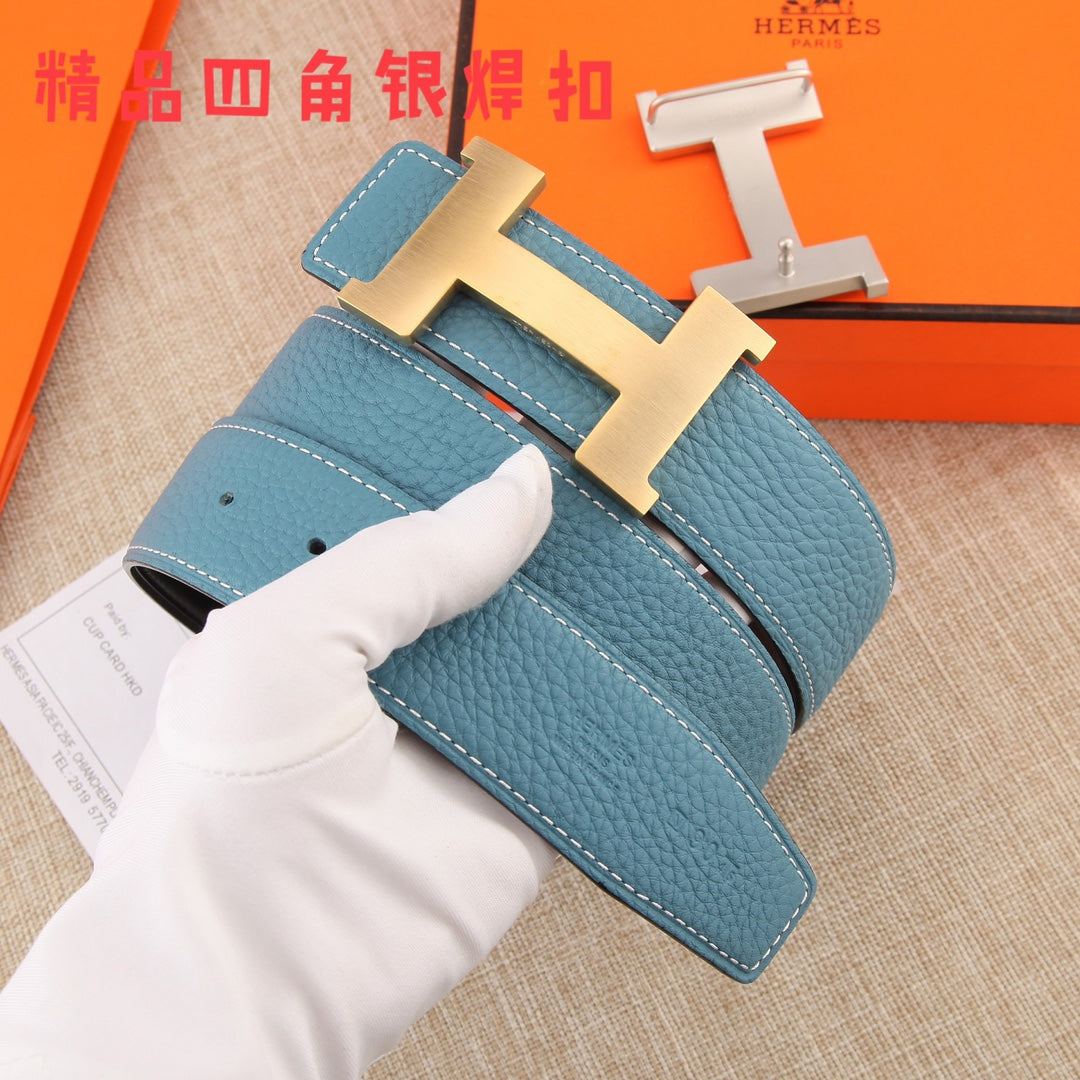 Hermes belt detail: blue strap with white stitching, metal H buckle, hole placement visible