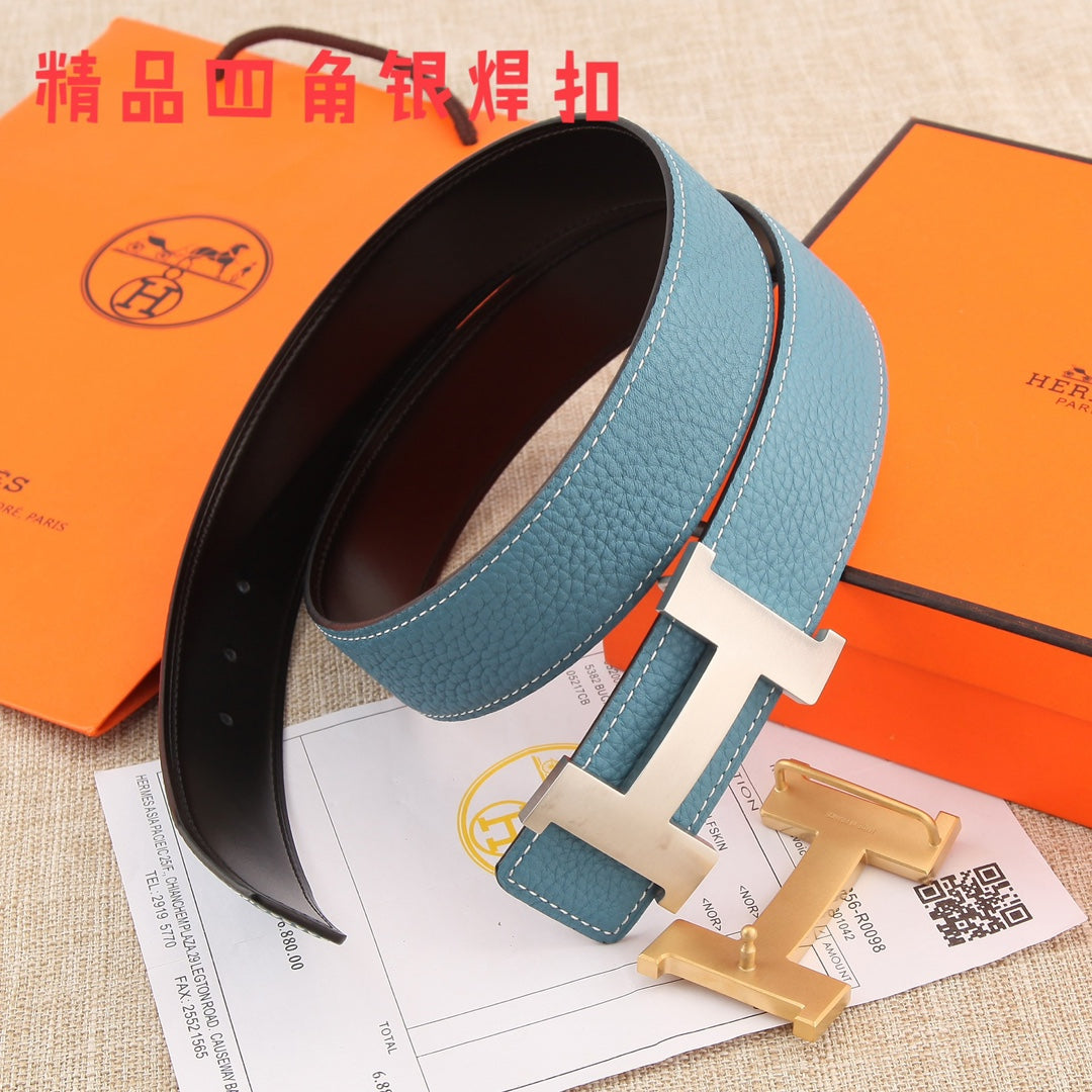 Hermes belt angled view: blue leather strap with white stitching, metal H buckle, black underside
