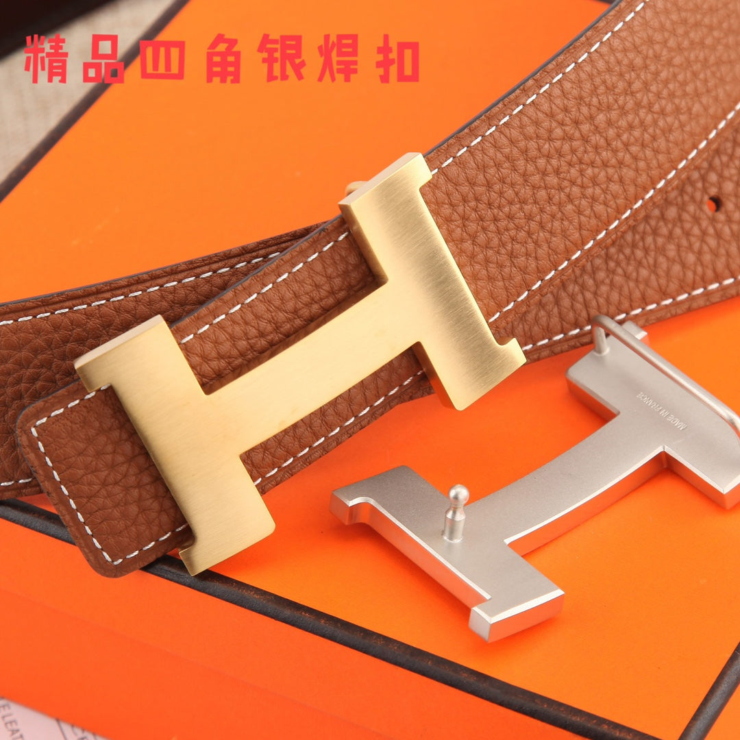 Hermes leather belt buckle with gold-tone H clasp and brown strap with white stitching.