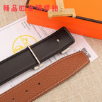 Hermes leather belt end with brown strap, gold-tone buckle, and black keeper panel.