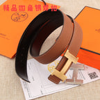 Hermes leather belt, brown strap with gold-tone H buckle and black inner backing.