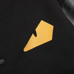 Yellow FENDI logo patch on black varsity jacket front near snap button placket